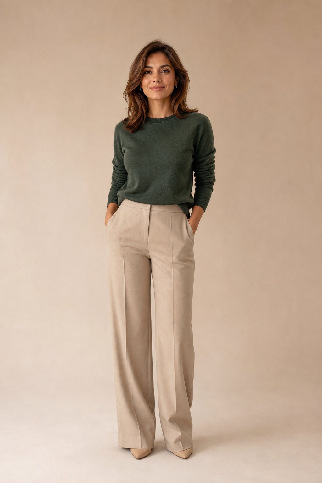 Petite woman in a forest green sweater and soft beige trousers, a crisp two tone color pairing that flatters